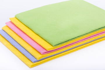 Multicolored cleaning napkins on white background