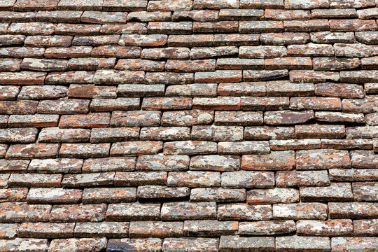 Old roof tiles background of a stone clay brick pattern and orange red texture found on the Mediterranean island of Cyprus, stock photo image 
