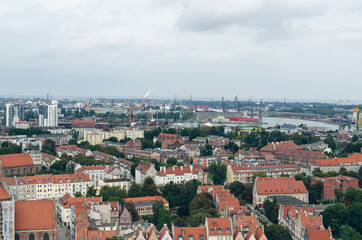 Fototapeta na wymiar POLAND, GDANSK: Scenic landscape view of city old center with traditional architecture with red roofs