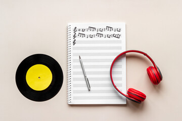 Sheets with music notes and headphones. Compose music concept