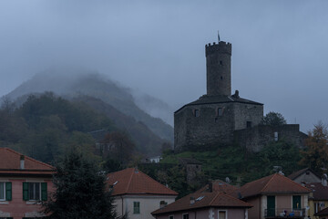 Fototapeta na wymiar Campo Ligure, Genoa. Castle overlooking the medieval town with clouds and Ligurian mountains in the evening after a storm