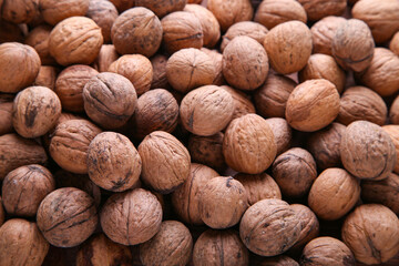 Whole walnuts background. Background of walnuts close up. A full source of vegetable protein. Concept - healthy eating.