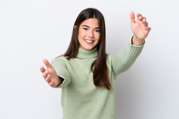 Young Brazilian woman isolated on white background presenting and inviting to come with hand