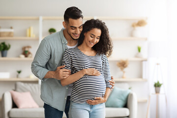 Loving middle-eastern husband hugging his beautiful pregnant wife - Powered by Adobe