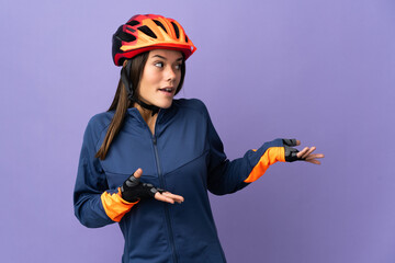 Teenager cyclist girl with surprise expression while looking side - obrazy, fototapety, plakaty