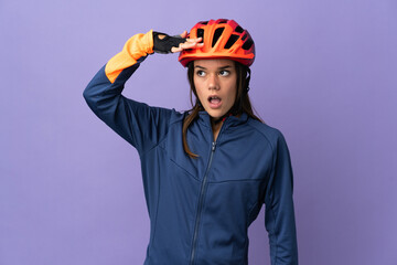 Teenager cyclist girl doing surprise gesture while looking to the side - obrazy, fototapety, plakaty