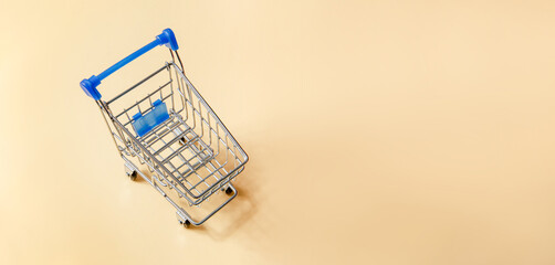 Shopping cart or supermarket trolley on yellow background, business finance shopping concept idea....