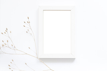 blank white photo frame with dry autumn flowers, art mockup