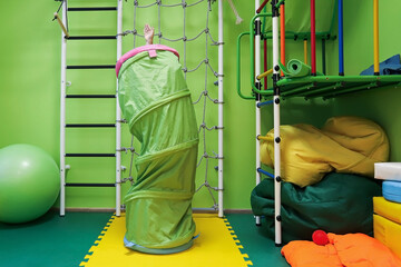 girl child in a special room plays and works on equipment for the treatment of problems with socialization in modern society