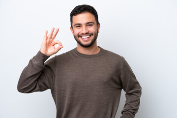 Fototapeta premium Young Brazilian man isolated on white background showing ok sign with fingers