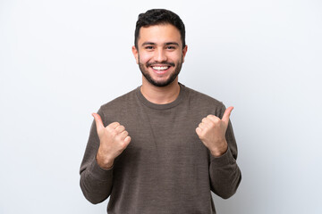 Fototapeta premium Young Brazilian man isolated on white background with thumbs up gesture and smiling