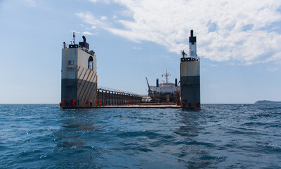 Semi-submersible ship is anchored with an open deck.