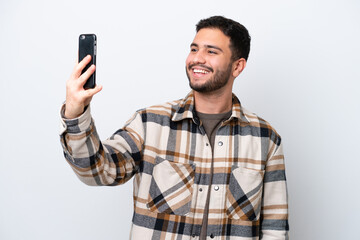 Young Brazilian man isolated on white background making a selfie