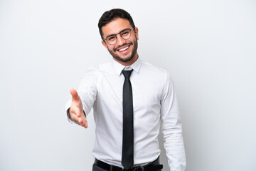 Business Brazilian man isolated on white background shaking hands for closing a good deal