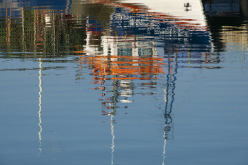 reflection of a fishing boats in the port of Portimao. Algarve, Portugal
