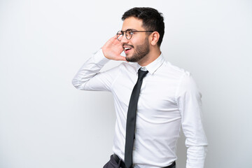 Business Brazilian man isolated on white background listening to something by putting hand on the ear