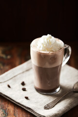 Coffee with whipped cream on dark background. Soft focus. Close up.	