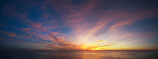 Sunset with red and yellow tones over the sea. © Ken4photo