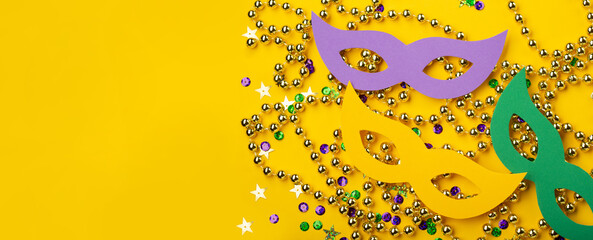 Mardi Gras Masquerade festival carnival masks, gold color beads and golden, green, purple confetti...