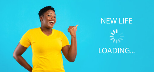Cheerful overweight black woman pointing aside at NEW LIFE loading throbber over blue studio...