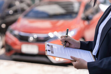 Insurance officer checking the car after the tenant have signed an auto insurance document or a...