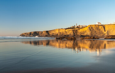 reflection in the water of Zambujeira do Mar beach, Costa Vicentina, Alentejo, Portugal.