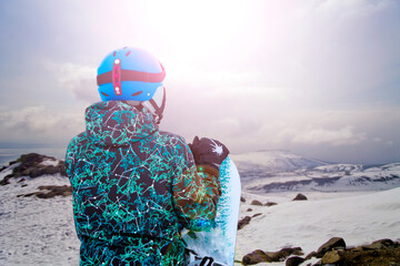 winter sports athlete on slope with snowboard in hand