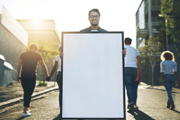 Display your creativity here. Shot of a young man holding up a placard outside.