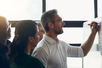 Follow my lead. Cropped shot of a mature businessman giving a presentation in the boardroom.
