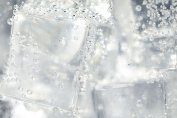 Soda water with ice as background, closeup