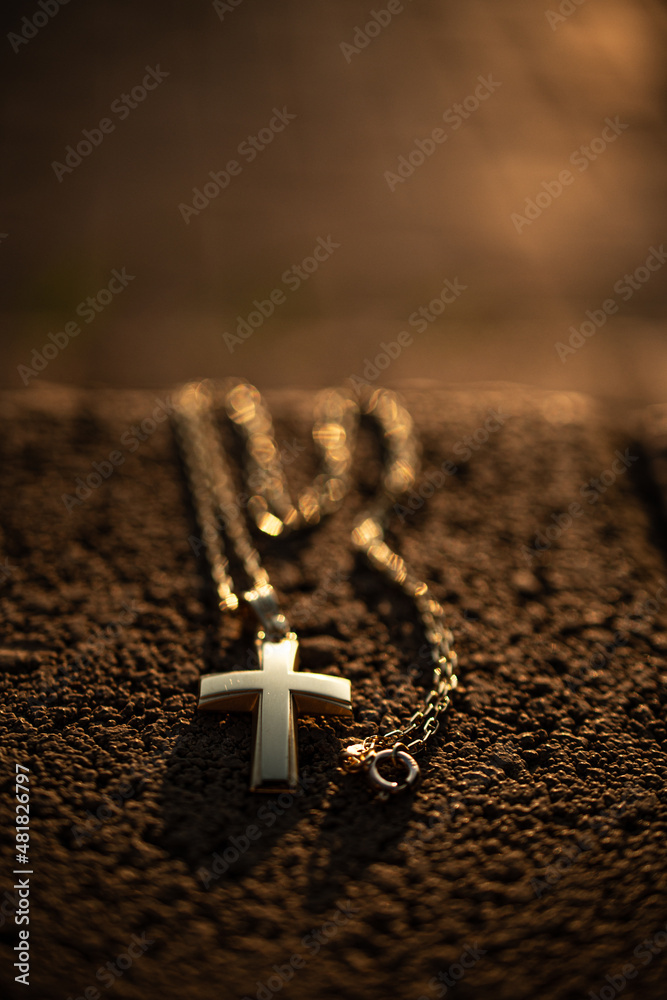 Wall mural Silver christian cross on wooden bench