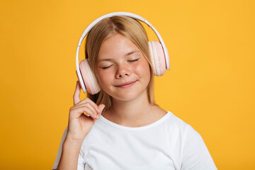 Portrait of calm cute european teenage female in white t-shirt with closed eyes in wireless headphones listen music