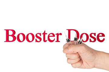 A hand holding glass syringes with a text booster dose on white background.