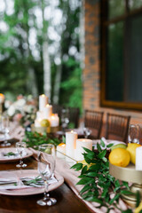 A beautiful outdoor wedding setting in pink flowers. Floral arrangements of white and pink fresh flowers. Lots of candles for dinner. 