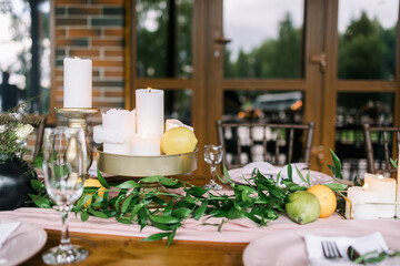 A beautiful outdoor wedding setting in pink flowers. Floral arrangements of white and pink fresh flowers. Lots of candles for dinner. 