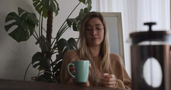 Girls has her morning coffee and looks out of window