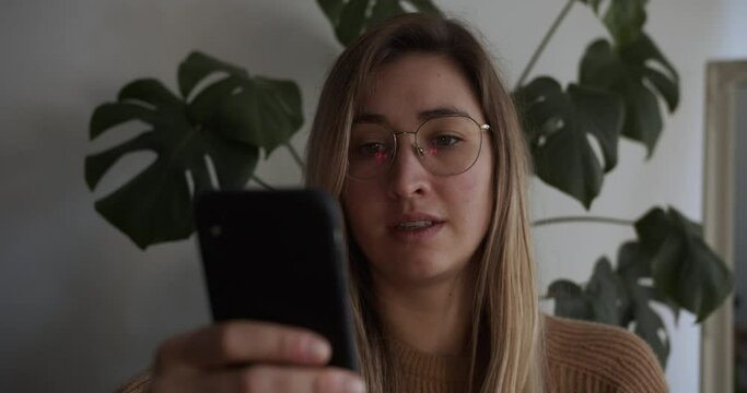 Close up of a woman scrolling on her smartphone