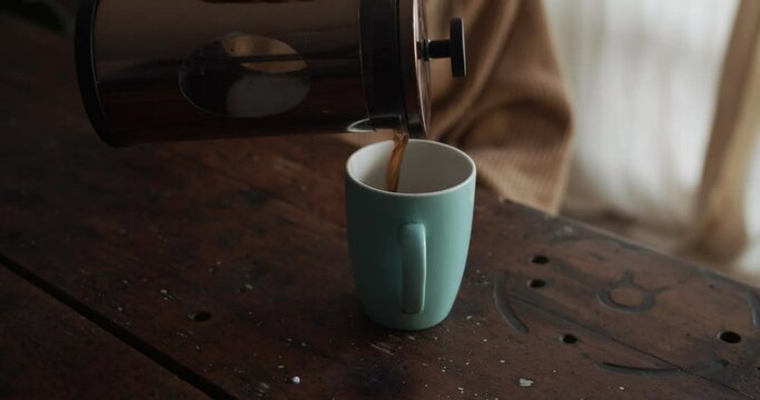 Girl pures coffee in her cup