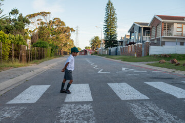 Young boy seen walking across pedestrian crossing