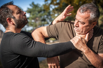 Street fighting self defense technique against holds and grabs