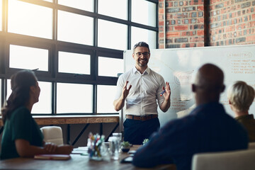 This is our target market. Cropped shot of a mature businessman giving a presentation in the boardroom.