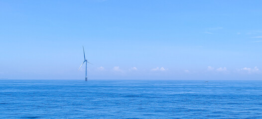 wind turbine to convert the wind's kinetic energy into electricity in Pearl River Estuary, China,...