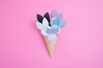Ice Cream cone with cute fluffy bunnies. Minimal Easter concept. Flat lay.