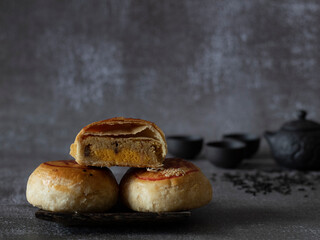 Tau Sar Piah (Savory Mung Bean Paste Biscuit) on rustic background with Chinese Tea Set with copy...