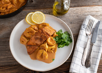 Salmon fillet with pasta and tomato cream sauce