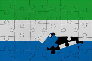 World countries. Broken puzzle- background in colors of national flag. Sierra Leone