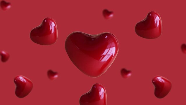 Flying and wiggle of different diameters red heart on trending red color gradient background. Romantic Love concept for mother's, St. Valentine's and women's day. Motion design graphics animation
