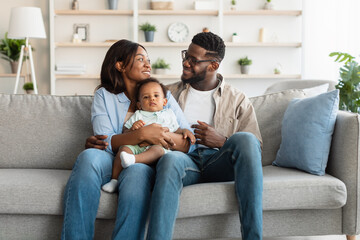 Portrait of happy black family smiling looking at each other