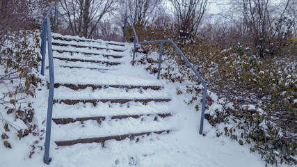 snow covered stairs in the park in cloudy light