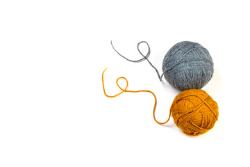 Knitted thread balls on white background with copy space.
